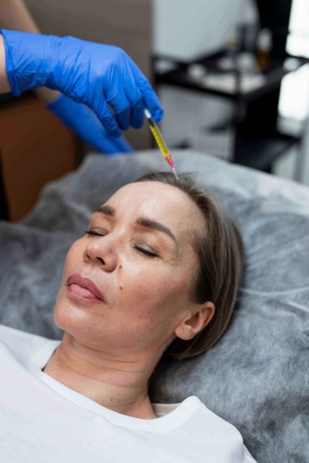 Aesthetic professional administering PRP therapy injection on a woman’s forehead at LeVogue Med Spa to promote youthful skin, hair growth, and natural collagen restoration.