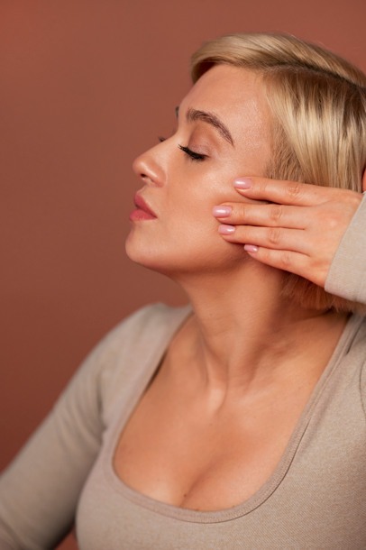 Woman showing defined jawline after Kybella injections for double chin reduction at LeVogue Med Spa in Temecula.