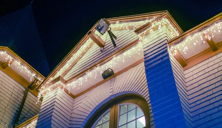 Home exterior illuminated with permanent outdoor lighting for year-round curb appeal.