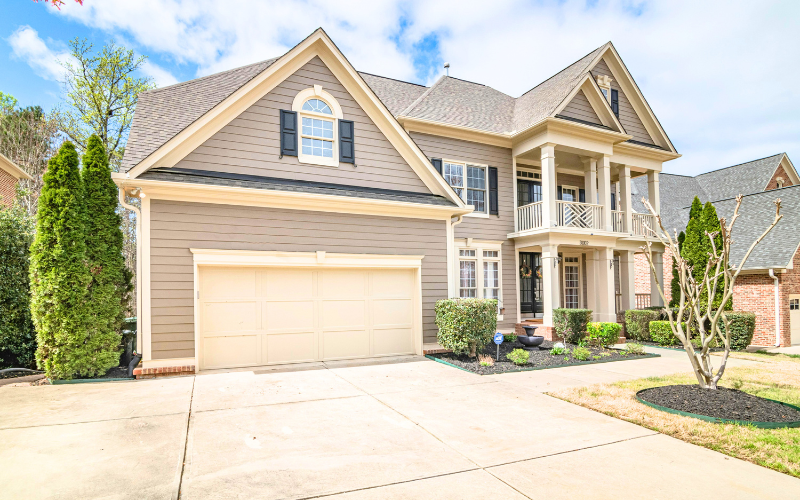 Clean residential home exterior with driveway and siding maintained by professional exterior cleaning services.