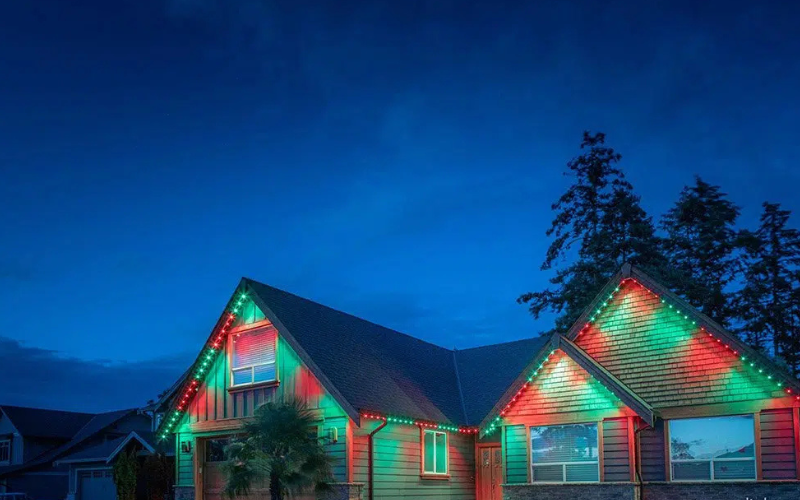 Residential home with customizable permanent outdoor lighting installed along the roofline.