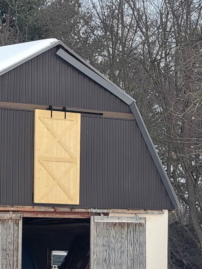 Vertical panel siding on outbuilding