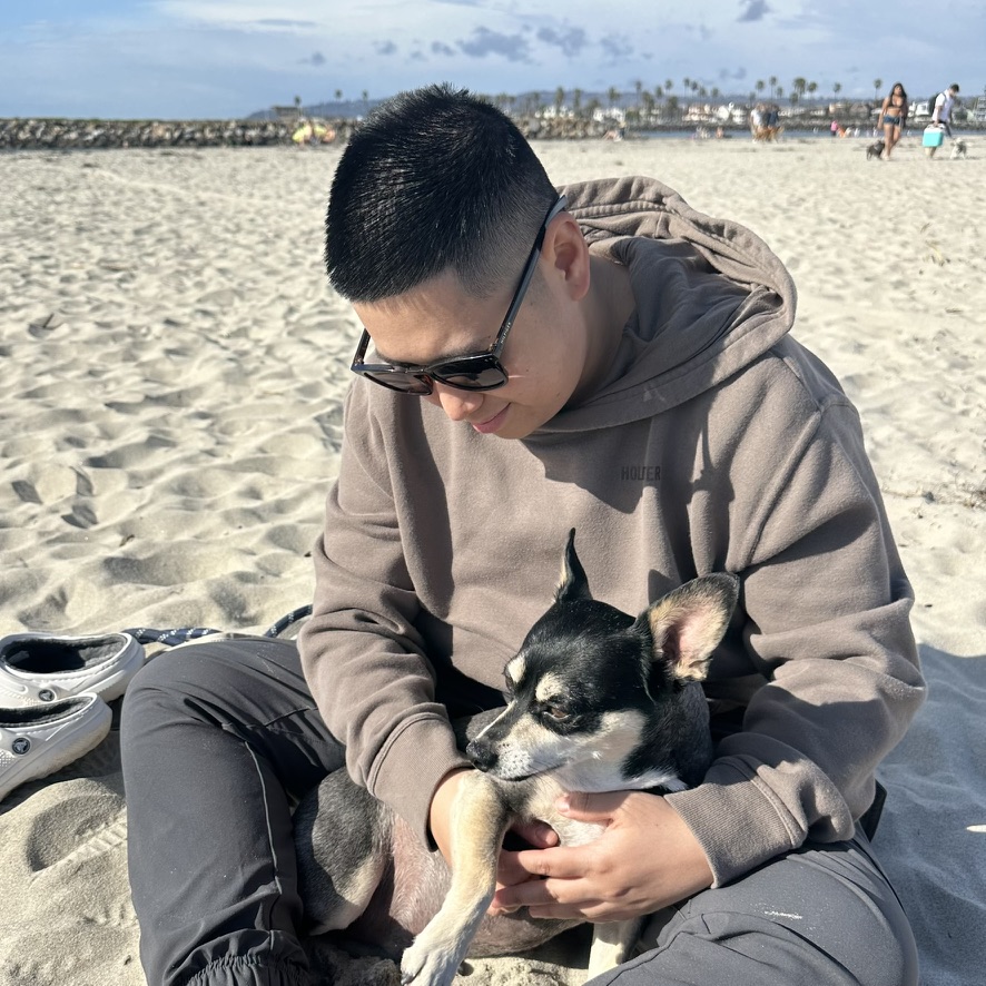 At the beach with a dog in my lap