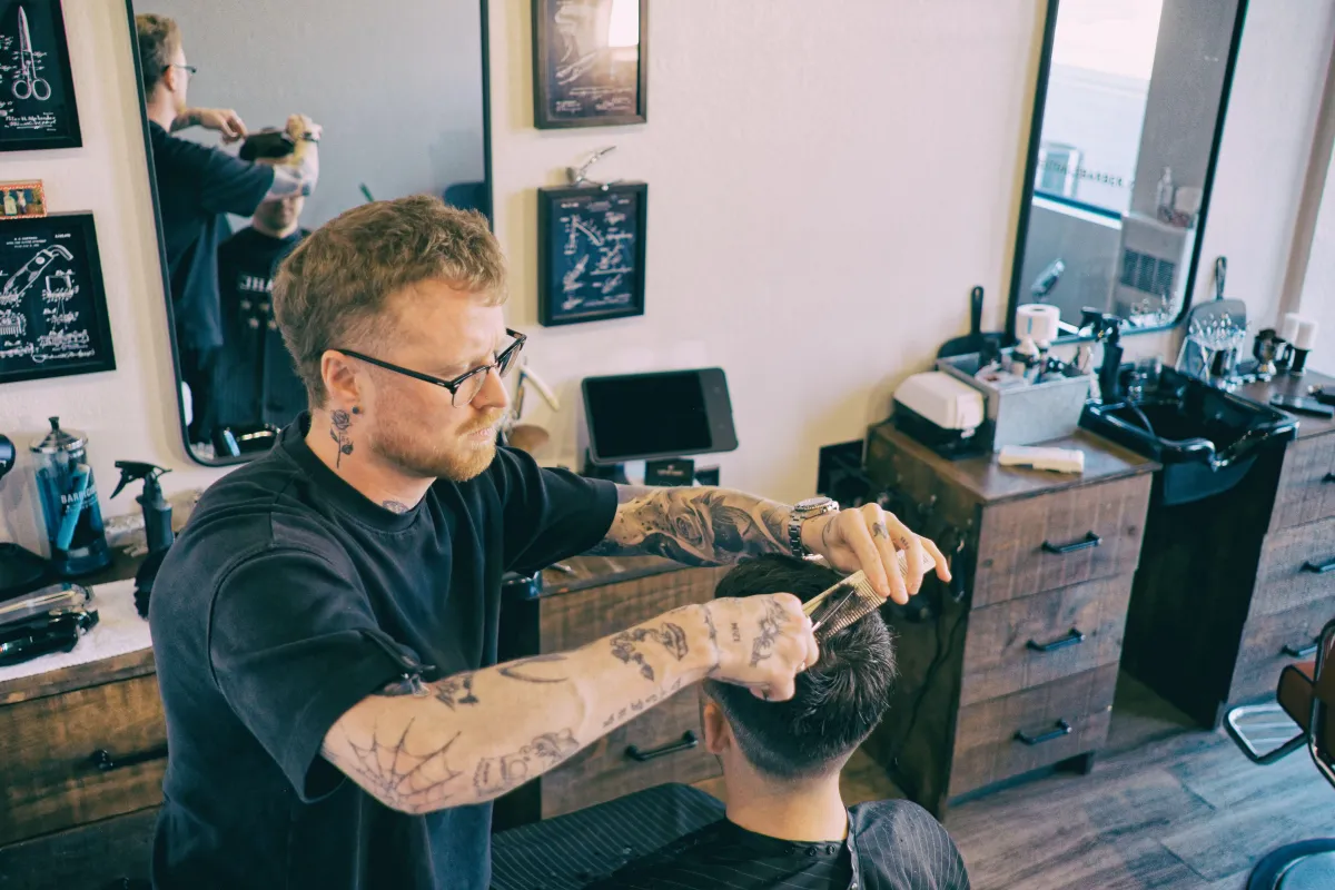 Gage working on a premium men’s haircut at Westdale Barbershop