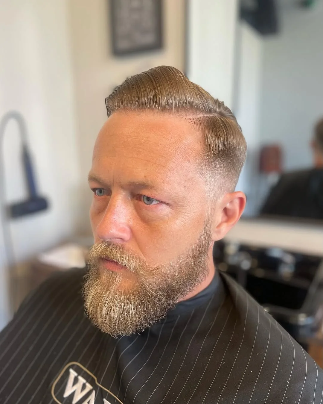 Premium men’s haircut with slicked back style and beard trim by Cuts By Gage