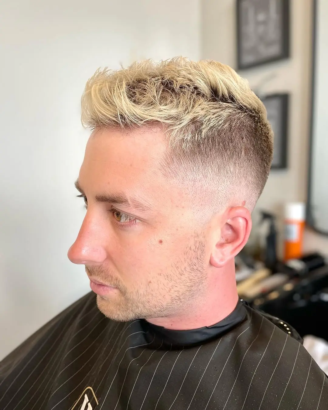 Clean skin fade with textured curls by Cuts By Gage