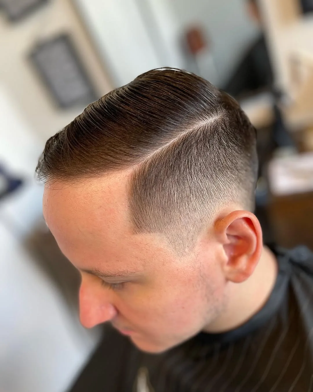 Classic side part haircut with clean fade by Cuts By Gage