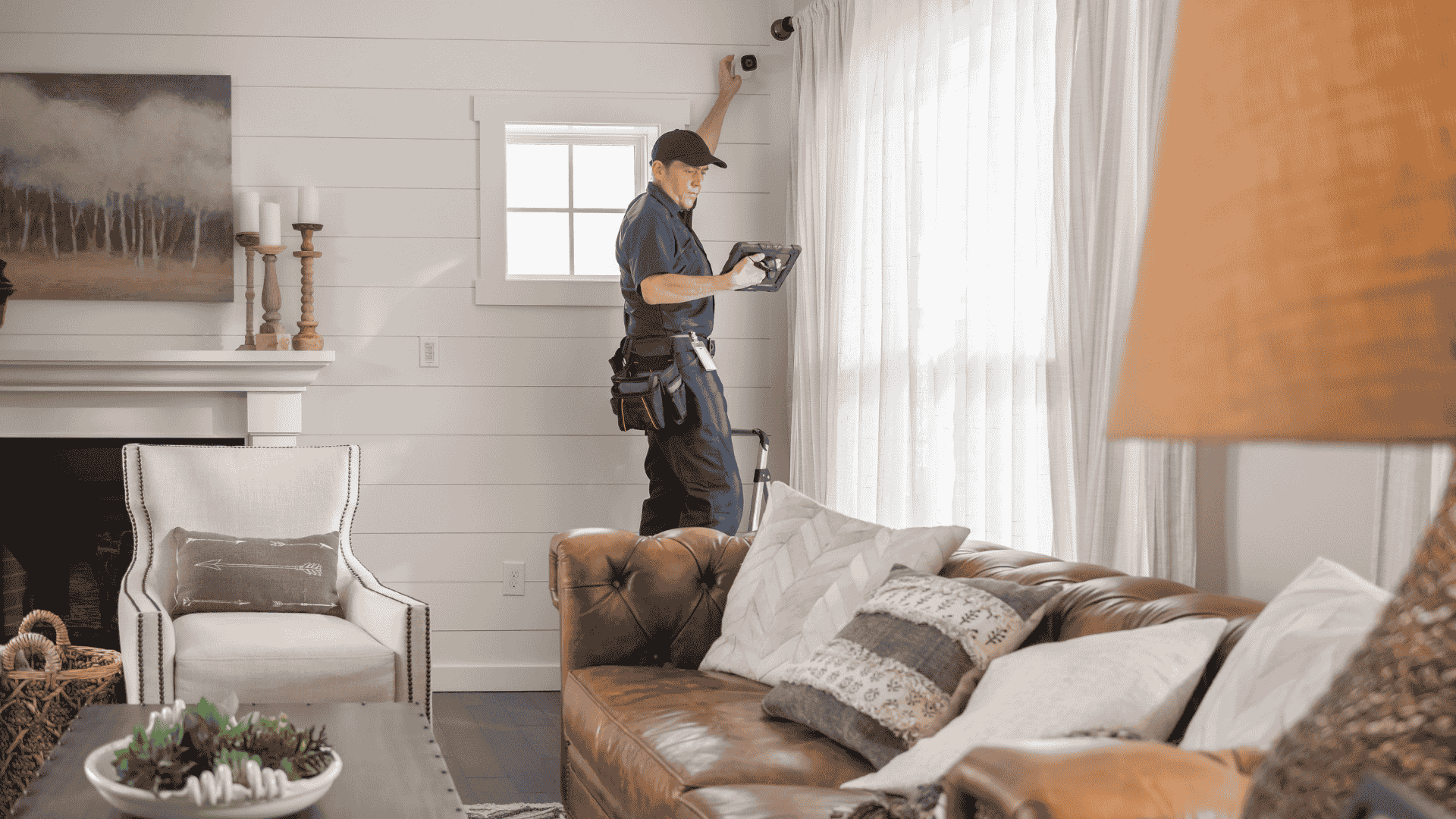 YCK Security installer mounting an indoor smart-home camera in a Utah home