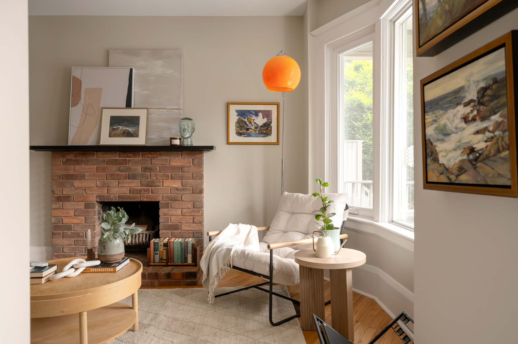 Living room with brick fireplace and bay window