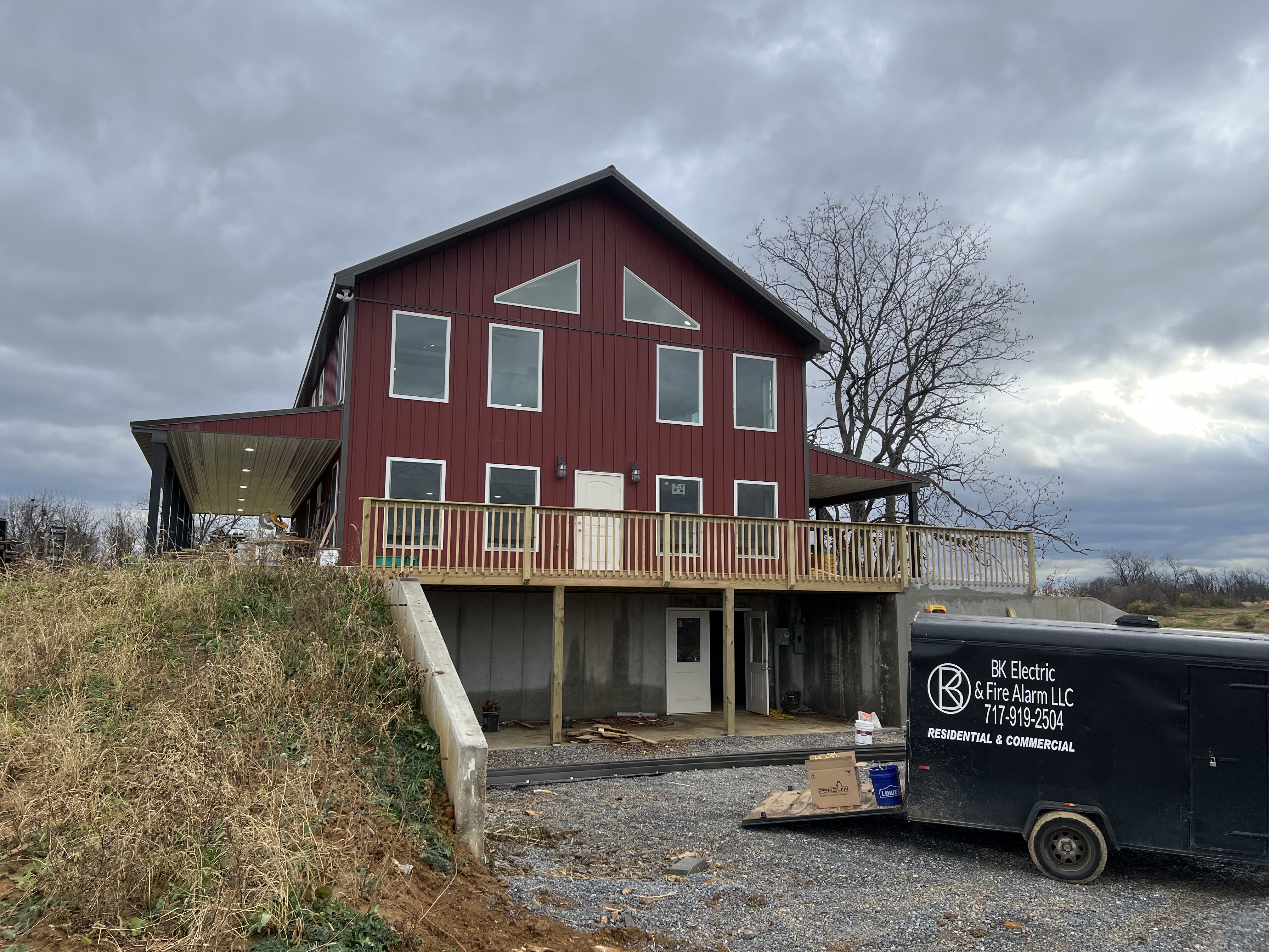 BK Electric and Fire Alarm trailer on a barndominium job site