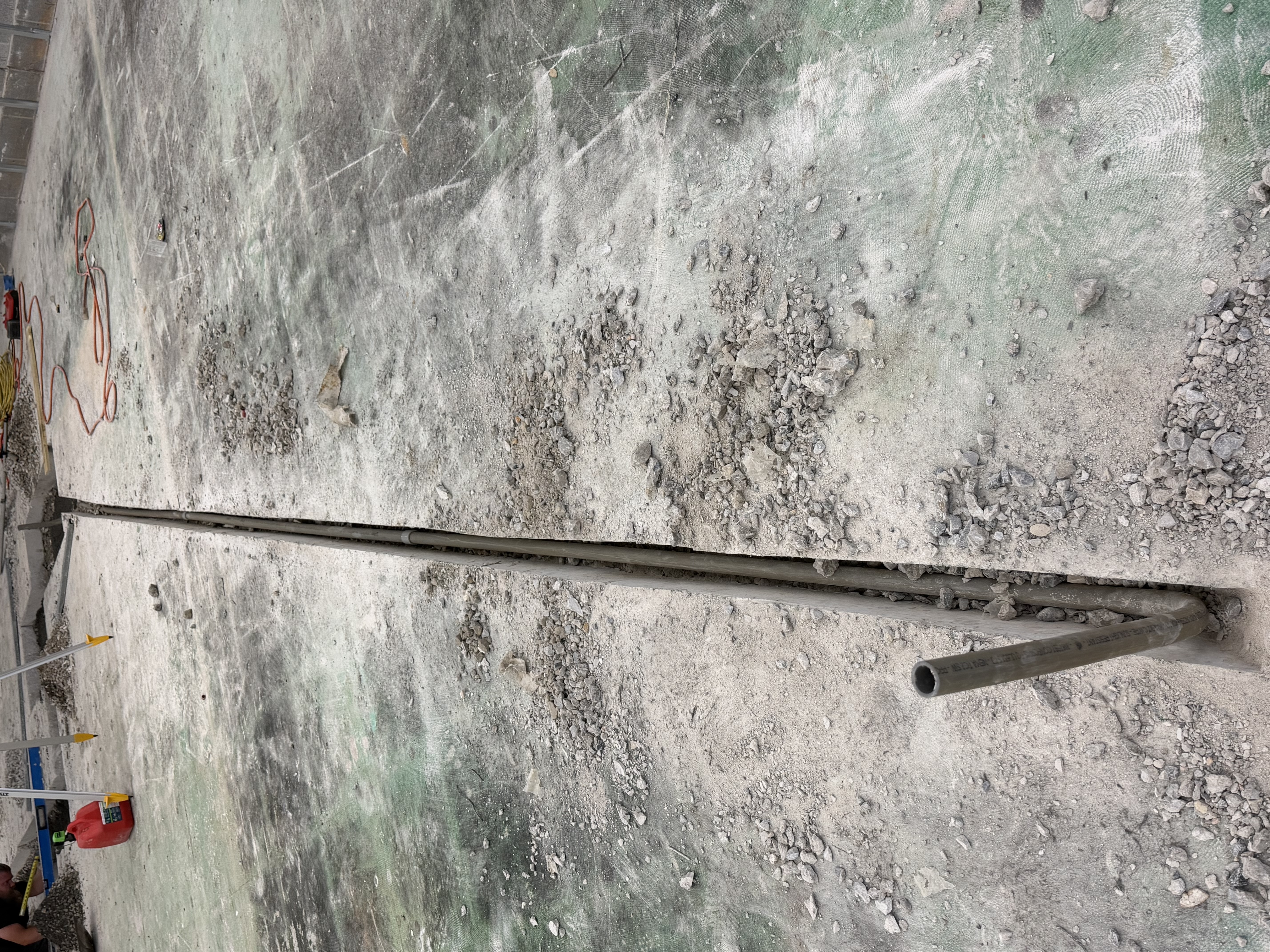 Conduit run through a trench cut in a concrete slab
