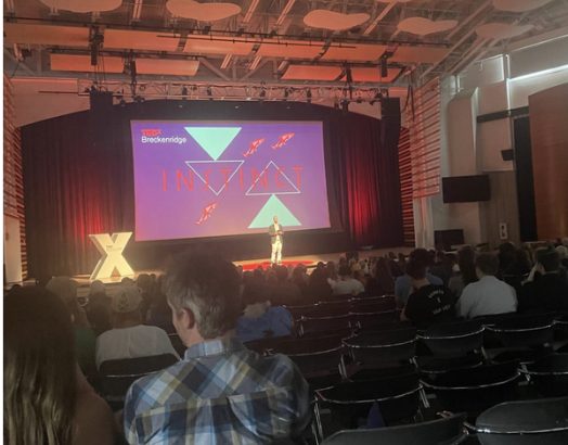 A speaker on stage at TEDx Breckenridge