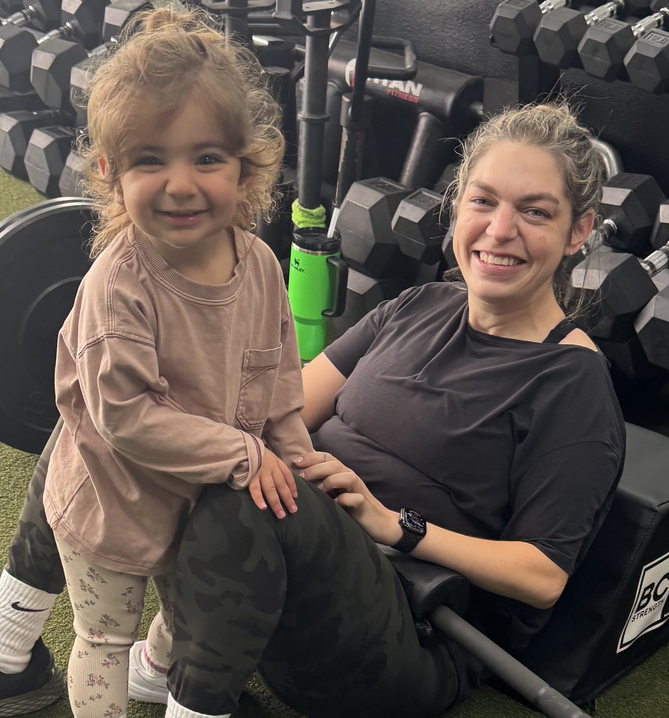 fit mom with young daughter working out