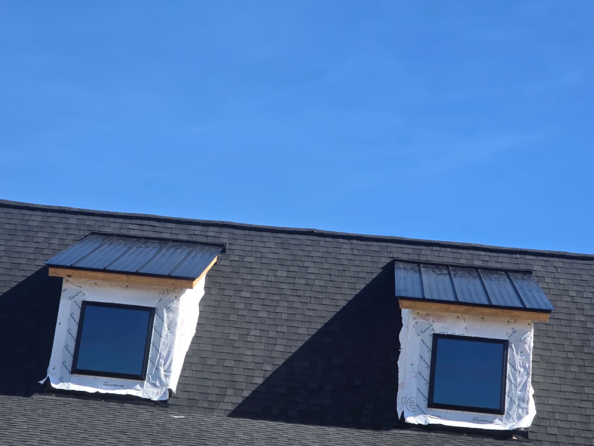 Standing-seam metal dormer roofs over architectural shingle