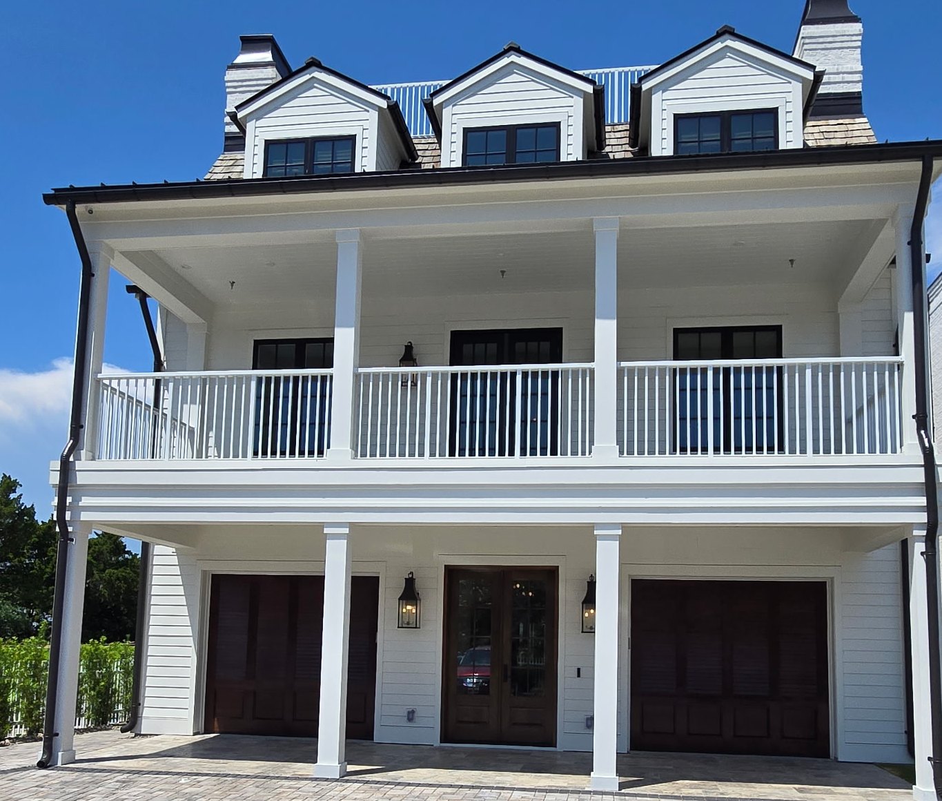 Finished coastal custom home with cedar shake and standing-seam metal roofing