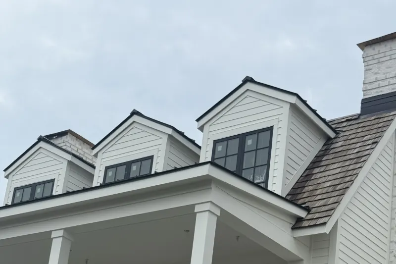 Cedar shake roof and three gabled dormers on a Beaufort custom home