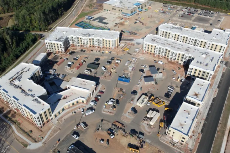 Aerial view of a multi-family apartment development during roofing