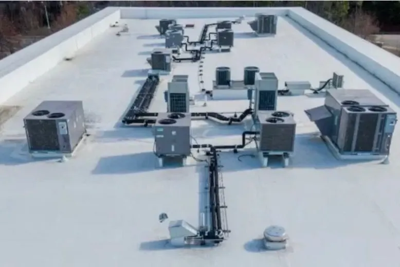 White TPO flat roof with rooftop HVAC units and curbs