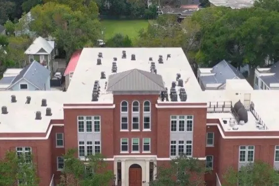 Aerial view of a low-slope roof on a brick institutional building
