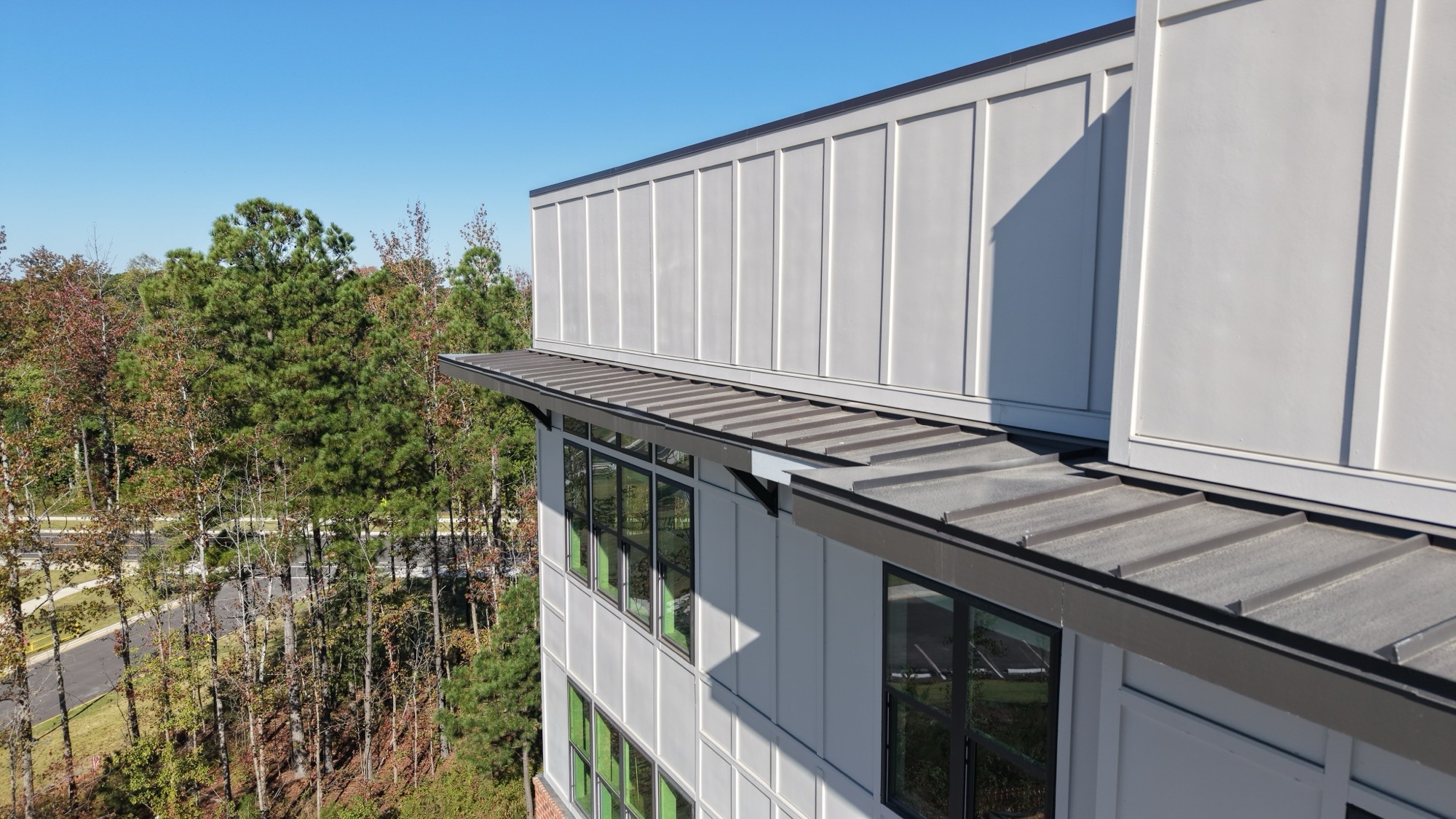 Standing seam metal roof on a multi-story building, installed by Central Carolina Roofing Systems