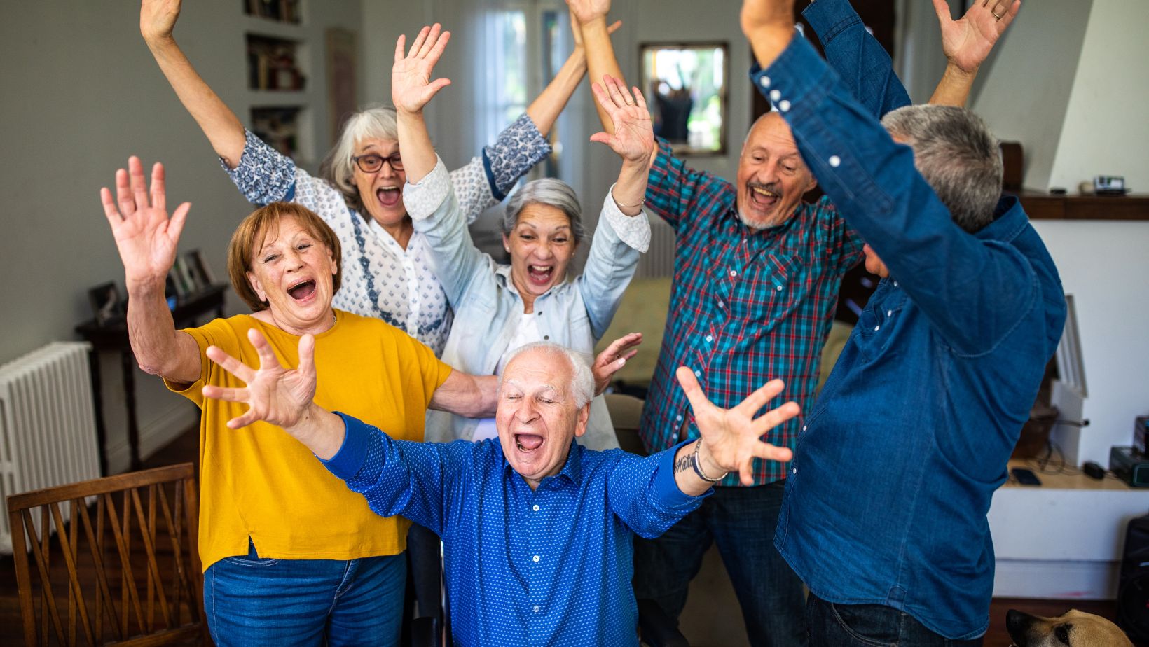 Group of smiling retirees cheering together