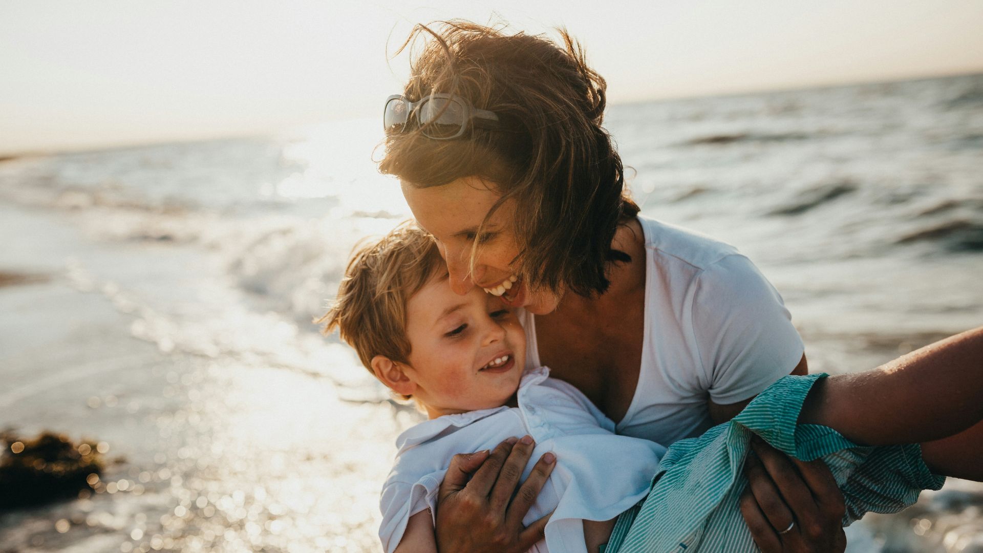 family holding onto one another at the beach