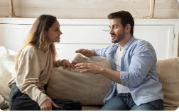 Couple talking face-to-face on a couch, rebuilding trust