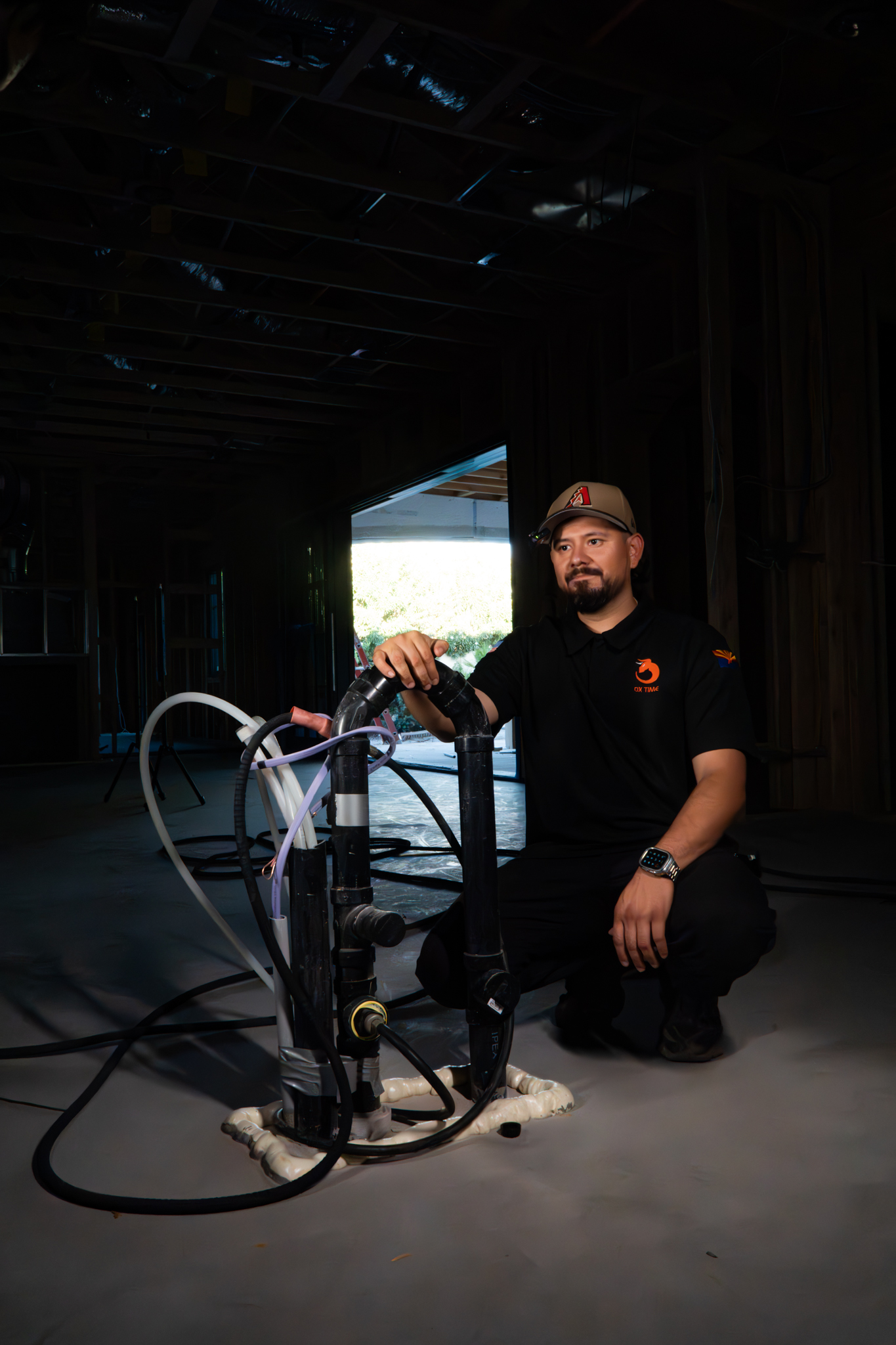 Erik, OX Plumbing owner, next to a kitchen island drain installation