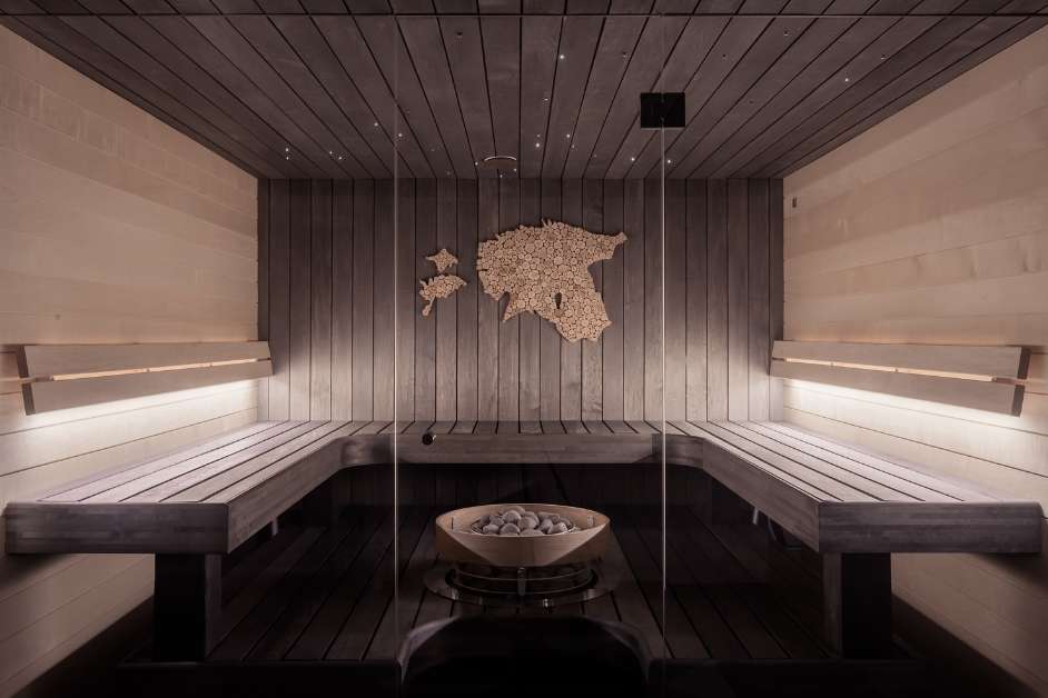 Custom indoor wood sauna with tiered bench seating