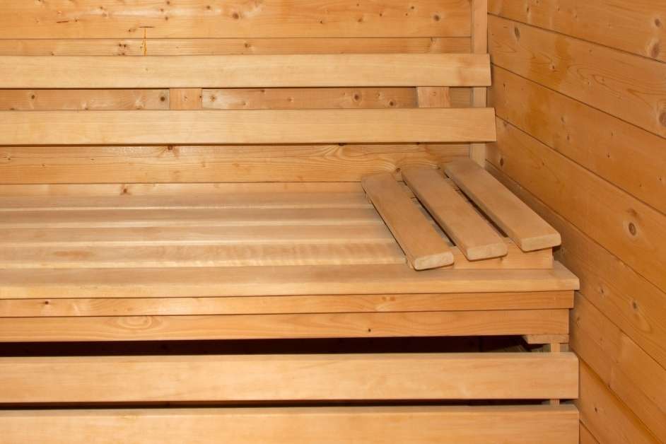 Modern custom sauna interior with wood benches and glass