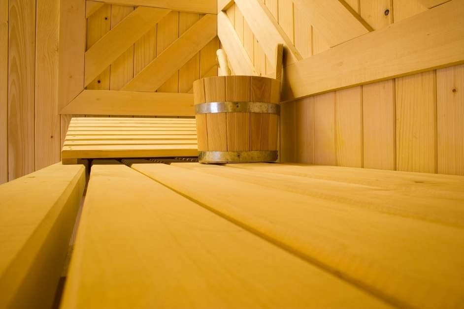 Custom home sauna interior with wood walls and benches