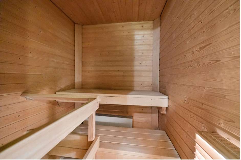 Modern wood sauna interior with custom bench layout