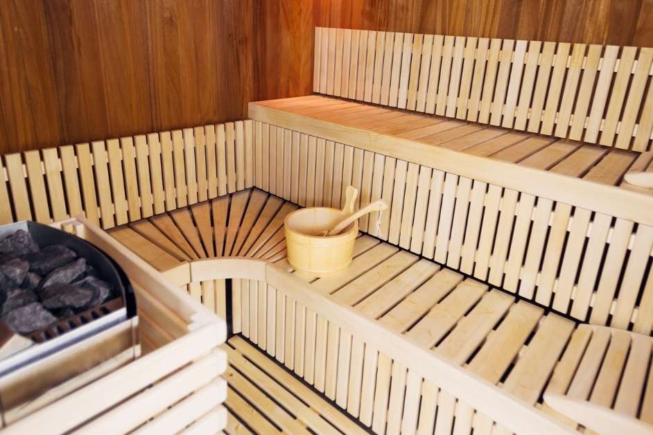 Indoor sauna with custom wood benches and warm lighting