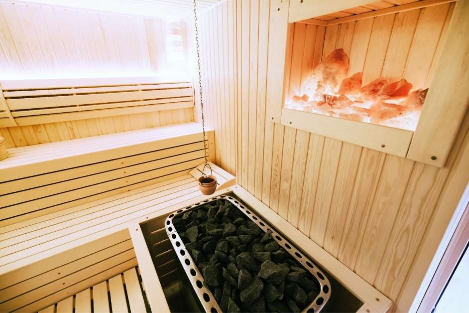 Wood sauna interior with custom benches and sauna heater