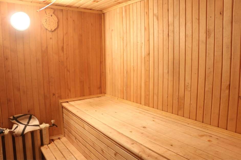 Custom indoor sauna with wood bench seating