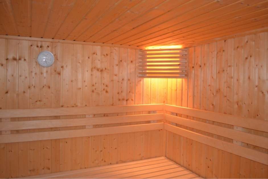 Custom indoor wood sauna with modern bench design
