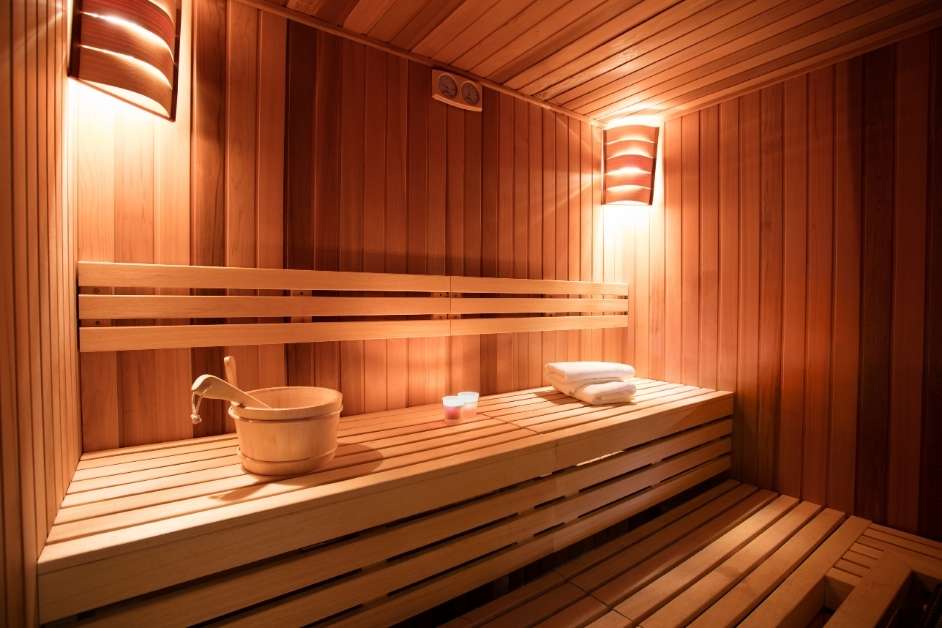 Modern indoor sauna room with wood bench layout