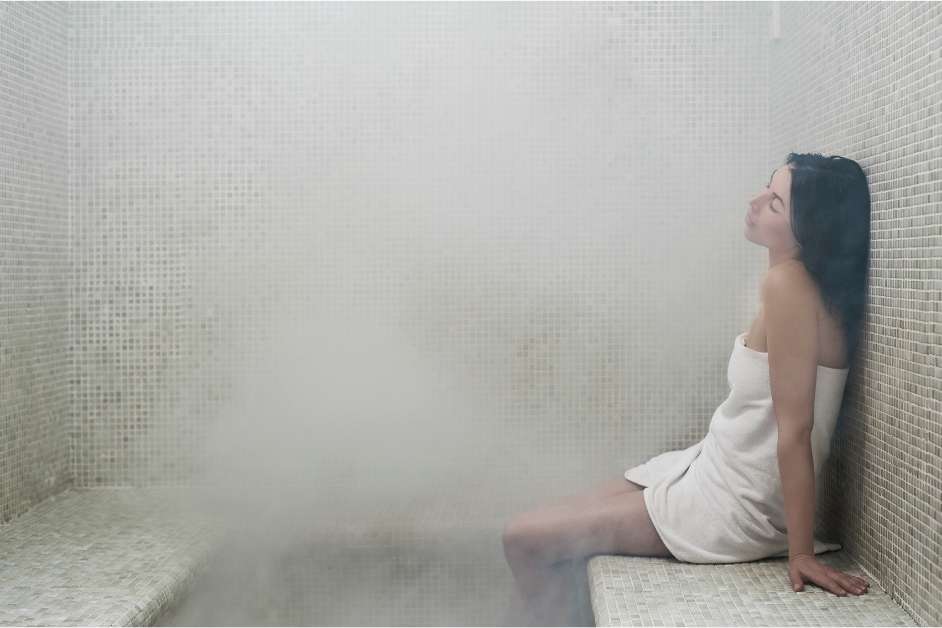 Stone and tile steam room with bench seating