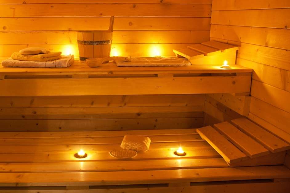 Traditional indoor sauna with wood walls and bench seating