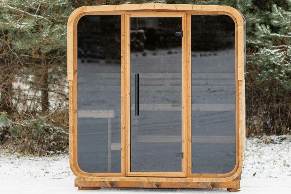 Modern outdoor sauna exterior with large glass opening