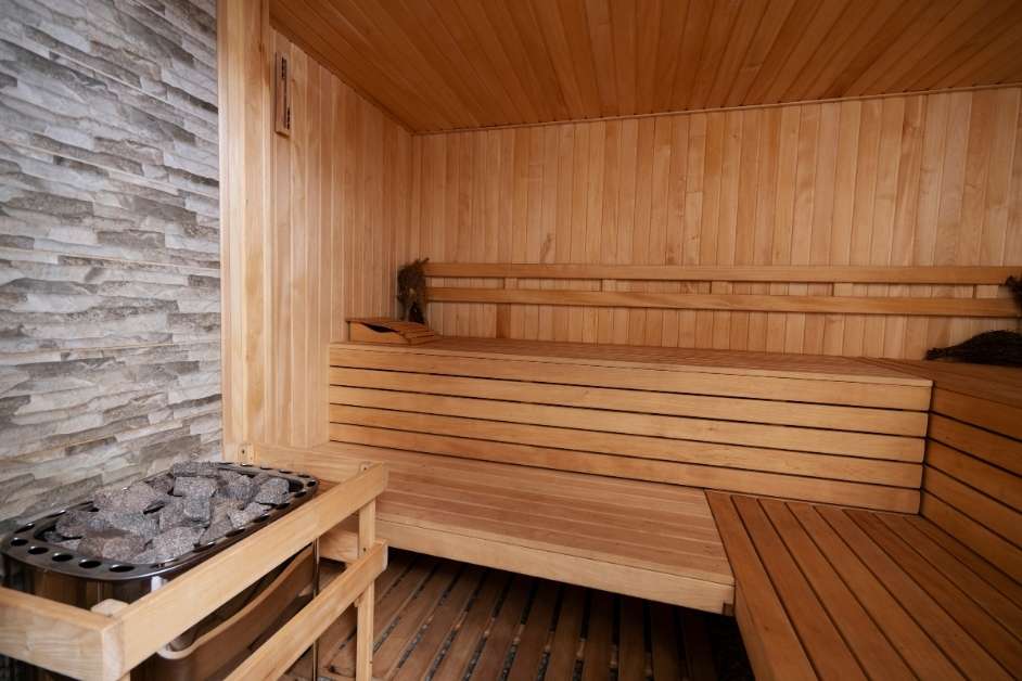 Modern sauna interior with wood benches and glass