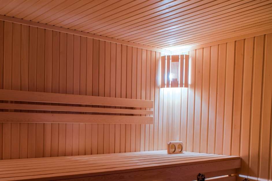 Modern indoor wood sauna with custom benches