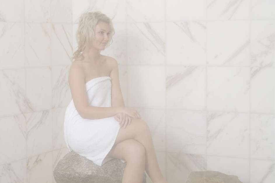 Custom tiled steam room with bench seating