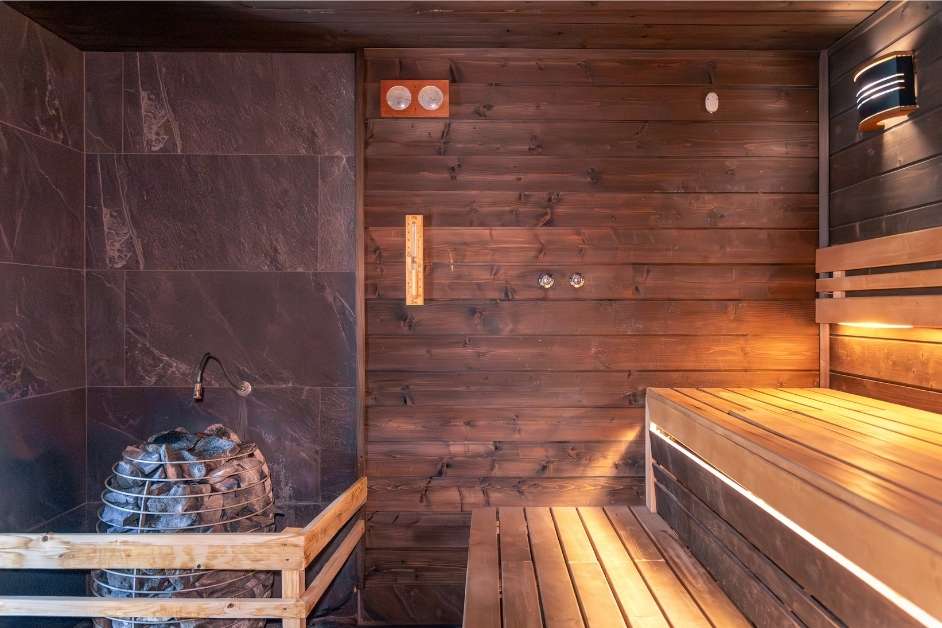 Custom wood sauna interior with benches and heater
