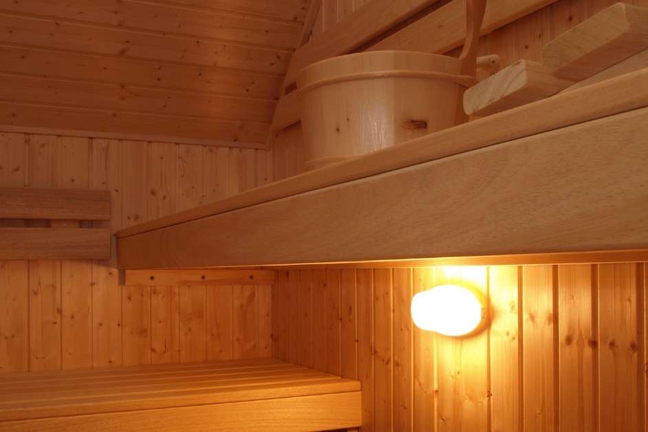 Custom indoor wood sauna with tiered bench seating