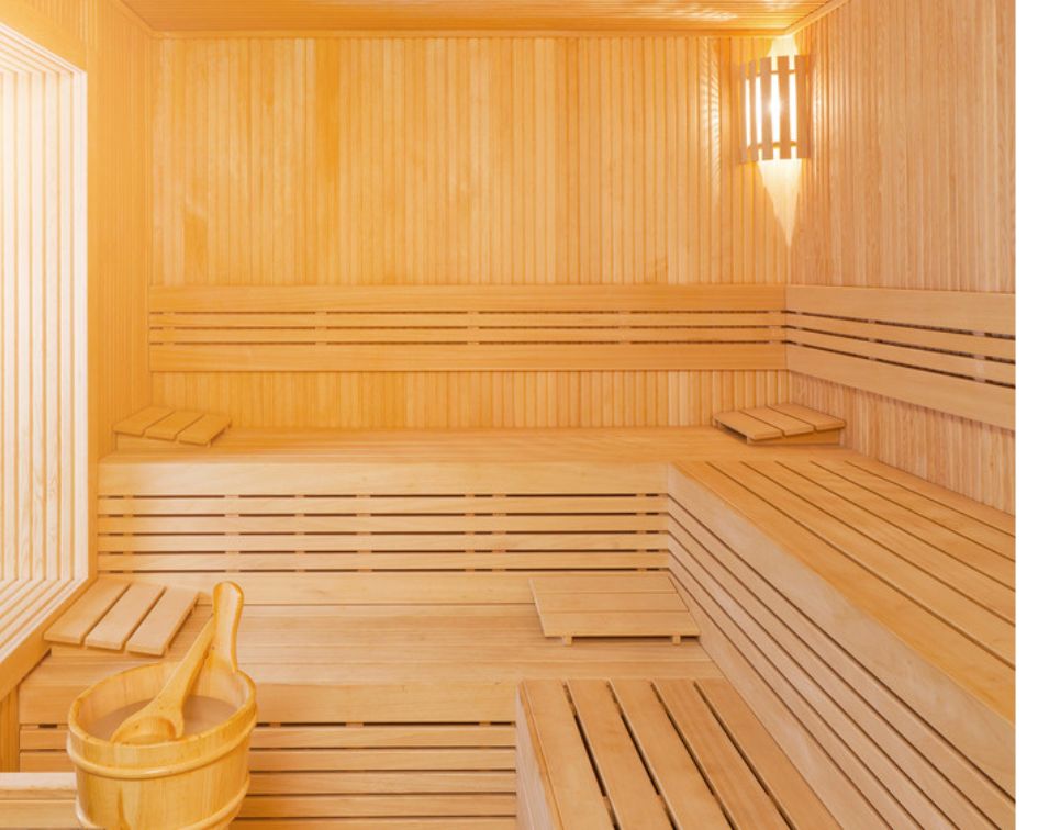 Bright commercial sauna with wide multi-level bench seating