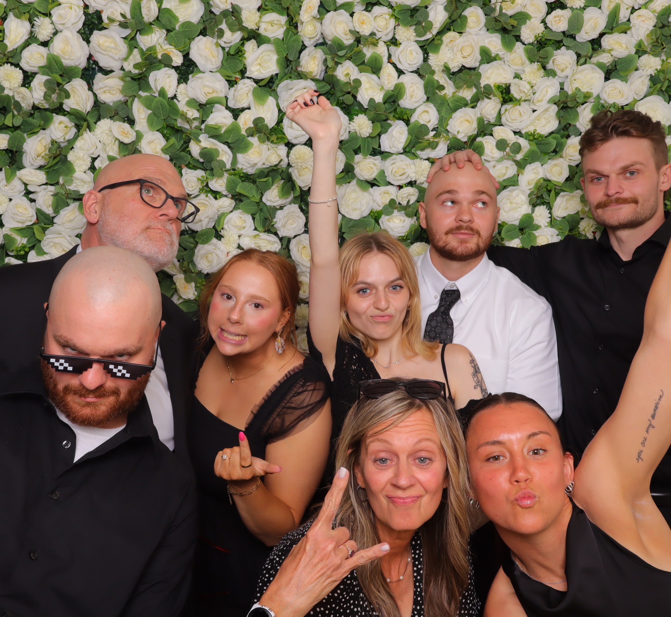 Guests making playful faces at a Photo-N-Go milestone celebration