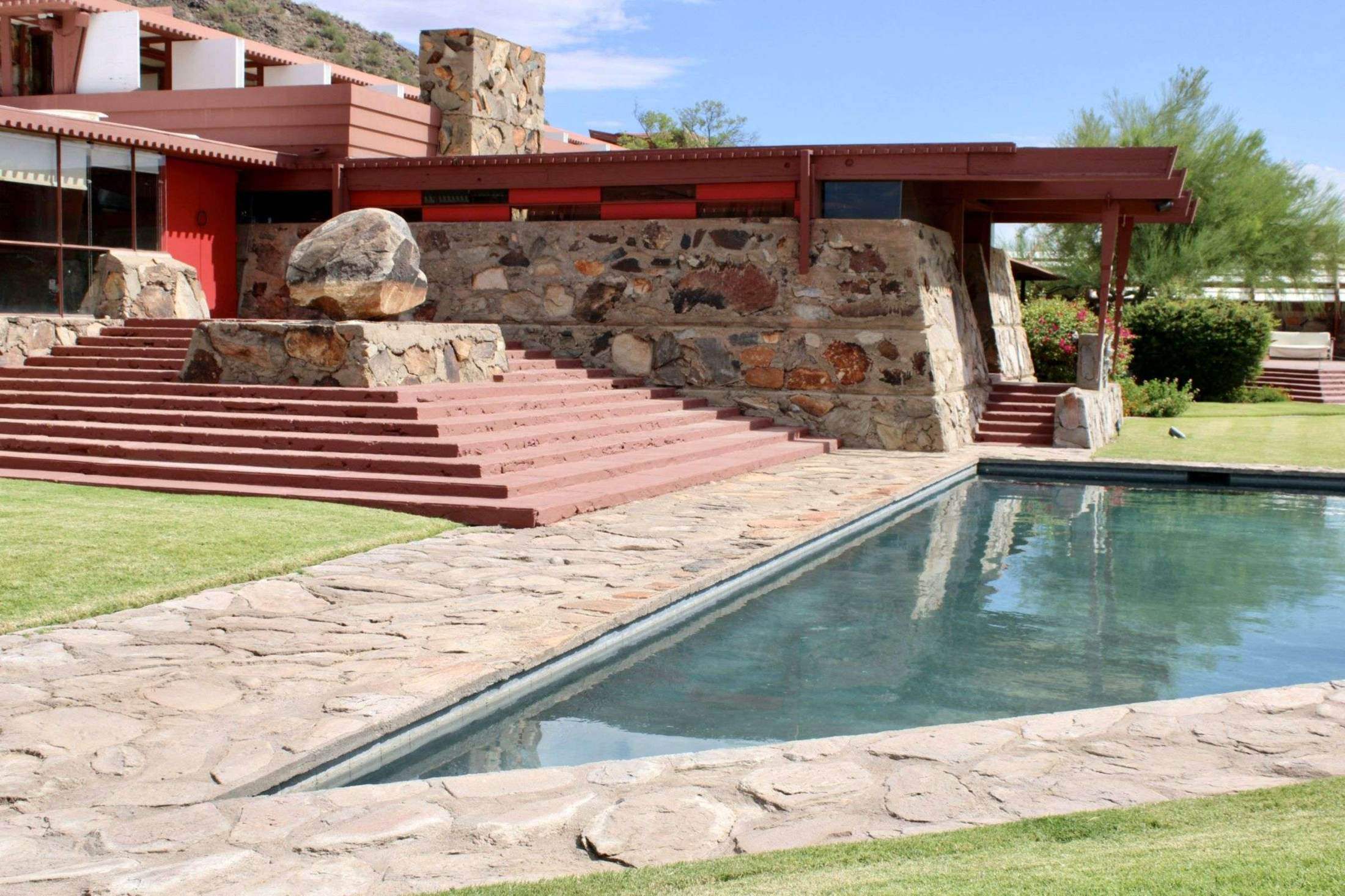 Desert modern home with a backyard pool under a clear blue sky