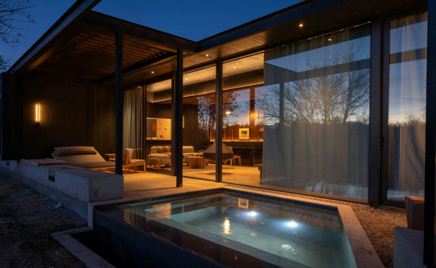 Modern desert home outdoor living with pool at dusk