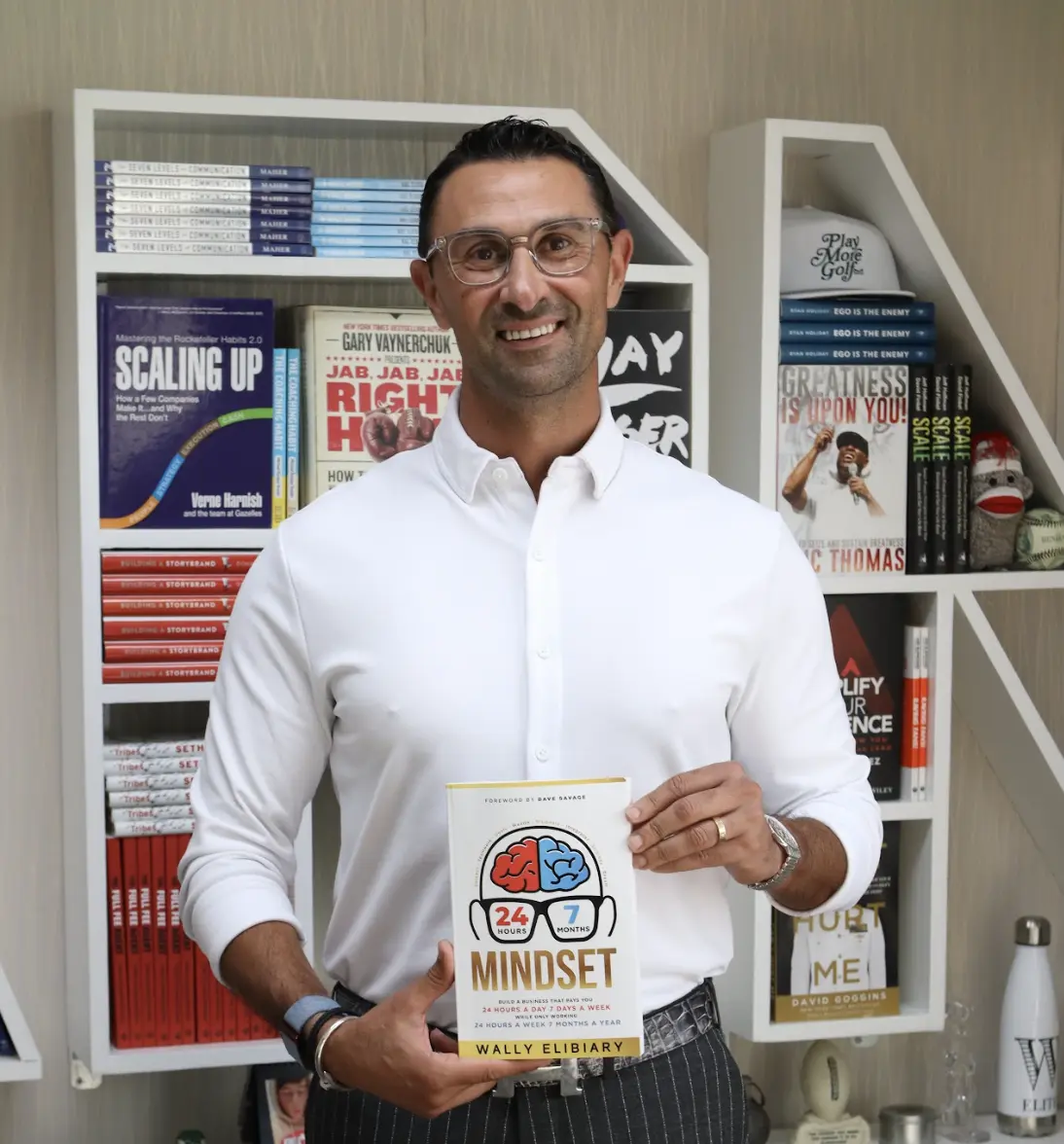 Wally Elibiary holding 24-7 Mindset book